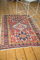 Vintage Karaja rug corner showing geometric XOXO border and primitive patterns.