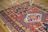Geometric rectilinear patterns and primitive drawing in red, navy, ivory on a Karaja rug.