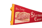 Red felt pennant featuring 'The Lodge' text, brick building graphic, and yellow binding.