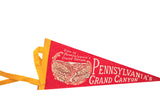 Red felt pennant with 'Pennsylvania's Grand Canyon' text and light-toned canyon illustration.