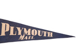 Close-up of vintage blue felt pennant with beige 'Plymouth Mass.' text, tapering right.