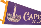 Vintage purple felt Cape May pennant detail, showing white lighthouse graphic and partial 'Cape' text.