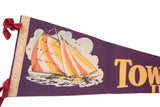 Vintage purple felt pennant's sailboat graphic, left edge, and red ties.