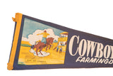 Detail of vintage Cowboy City felt flag with multicolor rodeo illustration and white text.