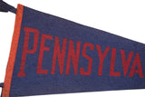 Vintage Pennsylvania felt flag close-up, bold maroon lettering on navy blue, with orange binding.