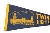 Yellow bound edge and vintage building graphic on the Twin Lights Highlands felt pennant.