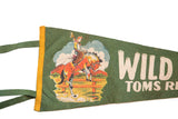 Green felt flag with white 'Wild Toms Ri' text and part of vintage cowboy graphic.