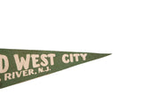 Right side detail of vintage green felt pennant, showing white 'WEST CITY' lettering.