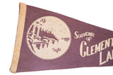 Cream edge binding and textured purple felt with partial lake scene graphic.