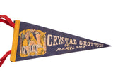 Close-up of the vintage graphic and text on the blue Crystal Grottoes felt flag.