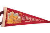 Vintage red felt flag detail with 'Gingerbread Castle' text and pointed tip.