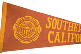 Yellow 'SOUTHERN CALIFORN' text on the aged orange-brown felt of a vintage flag.