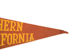 Pointed orange felt tip of the USC flag with yellow lettering and visible edge loss.