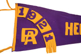 Arched 1921 date and entwined PA letters in gold felt on a vintage purple pennant.