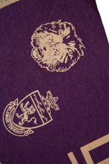 Close-up of the vintage purple felt Delaware Township High crest, showing lion emblem.