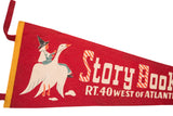Vintage red felt flag showcasing candy cane stylized 'Story Book' lettering and witch riding a goose.