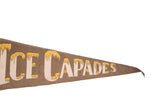 Vintage Ice Capades felt pennant's pointed tip with 'CAPADES' lettering and yellow icicle details.