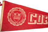 Detailed white Cornell University crest on red felt flag, showing founding inscription.