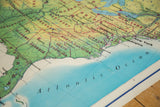 Detail view of vintage USA map, showing green East Coast states bordering blue Atlantic Ocean.