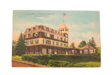 Vintage postcard of the Elka Park Club House in Tannersville, NY, with an American flag on the roof.