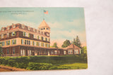 Angled view of the vintage Elka Park Club House postcard showing its paper surface.