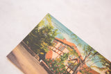 Angled view of colorful Tudor house and 'Library at Onteora Park' text on vintage postcard.