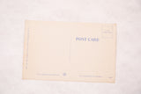 Reverse side of a vintage postcard showing the divided back and publisher's mark in blue ink.