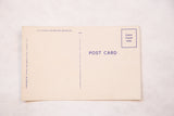 Cream reverse of vintage postcard, showing purple 'POST CARD' text and stamp box.