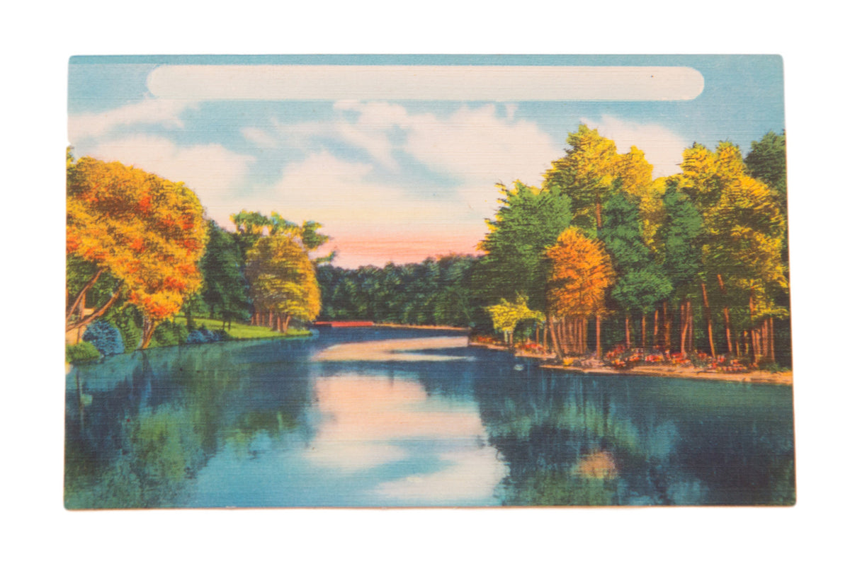 Vintage Catskills postcard of a serene lake reflecting trees with vibrant autumn foliage.