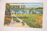 A vintage postcard of a Catskills lake scene, shown from an angle.