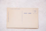 Back of vintage postcard with blue 'POST CARD' text and one-cent stamp box.