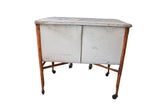 Vintage double wash tub, distressed white with rusty frame, lid, and wheels.