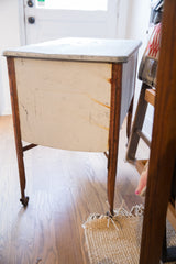 Wash tub's side panel showing peeling white paint and rustic metal leg.