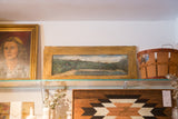 Antique folk art landscape painting on rustic wooden shutter door.