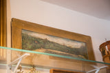 Distressed wooden frame and folk art landscape painting corner detail.
