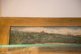 Antique landscape painting on door showing worn wooden top and painted sky.