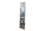 Tall reclaimed circa 1930s copper door mirror with chipping white paint.