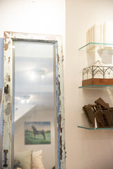 Chipping cream paint and subtle scratches on the reclaimed copper door mirror glass.