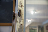 Reclaimed Copper Door Mirror with chipping white paint, vintage handle, and scratched glass.