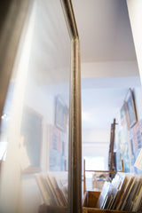 Close-up of the vintage reclaimed copper mirror frame with aged patina.