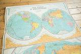 Antique Nystrom world map displaying pastel hemispheres, significant creases, and canvas discoloration.