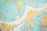 Close-up of the antique Nystrom map displaying North America, Europe, Greenland with canvas patina.