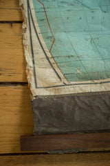 Bottom section of antique Nystrom pull-down map, showing copyright, torn canvas, and walnut rod.