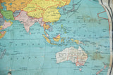 Antique Nystrom world map section showing Australia, New Zealand, and stiff, discolored canvas.