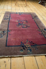 Camel border with navy and cobalt blue vase and plant motifs on a Chinese Art Deco rug.