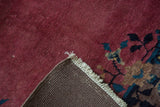 Hand-knotted cochineal plum pile, original side cord selvage, and secured fringe.