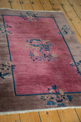 Gray border with blue, beige vases and plants on wine red Chinese Art Deco rug.