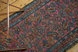 Textural view of vintage Lilihan rug with purple plum herati motif and sky blue border.