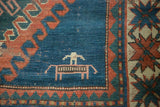 Vintage Caucasian rug, indigo field with herdsman corralling animal motif.