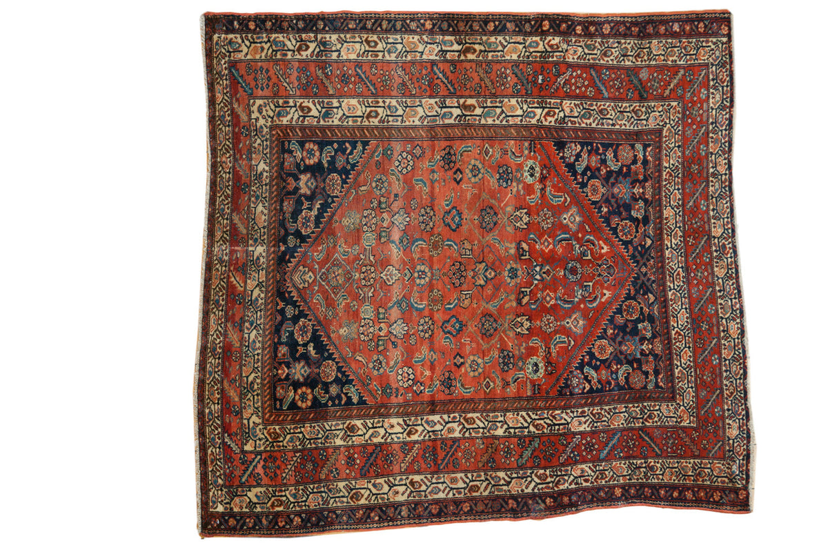 Fine antique Malayer square rug, brick red field, indigo diamond, and herati motifs.
